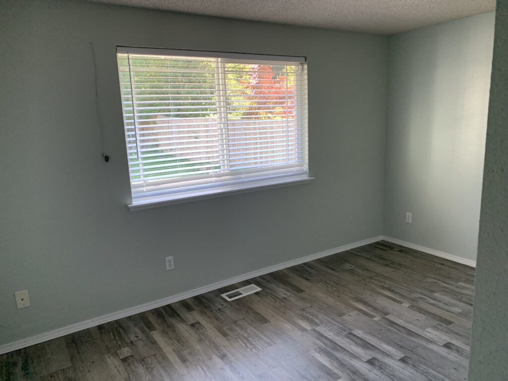 new flooring and trim. After image of wall hole repairs by Woodgrain Construction