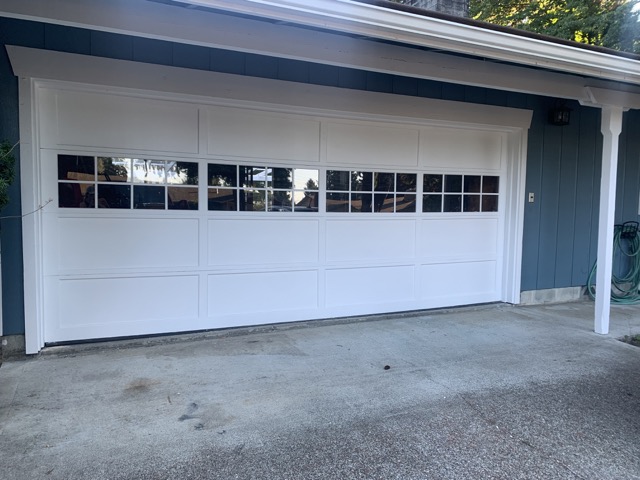 After garage door renovation. Fresh paint, clean windows and detailing to windows.